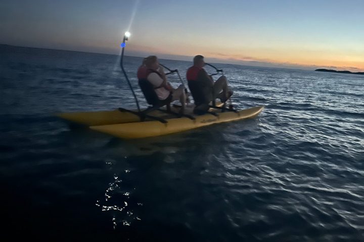 a man riding on the back of a boat in a body of water
