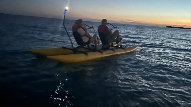 a man riding on the back of a boat in a body of water