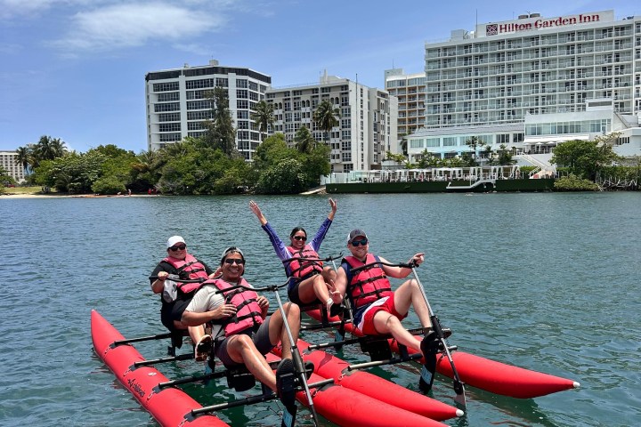 a group of people in a small boat in a body of water