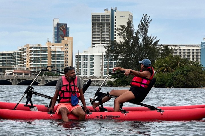 a person riding on the back of a boat in a body of water