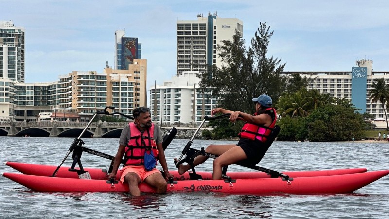 a person riding on the back of a boat in a body of water