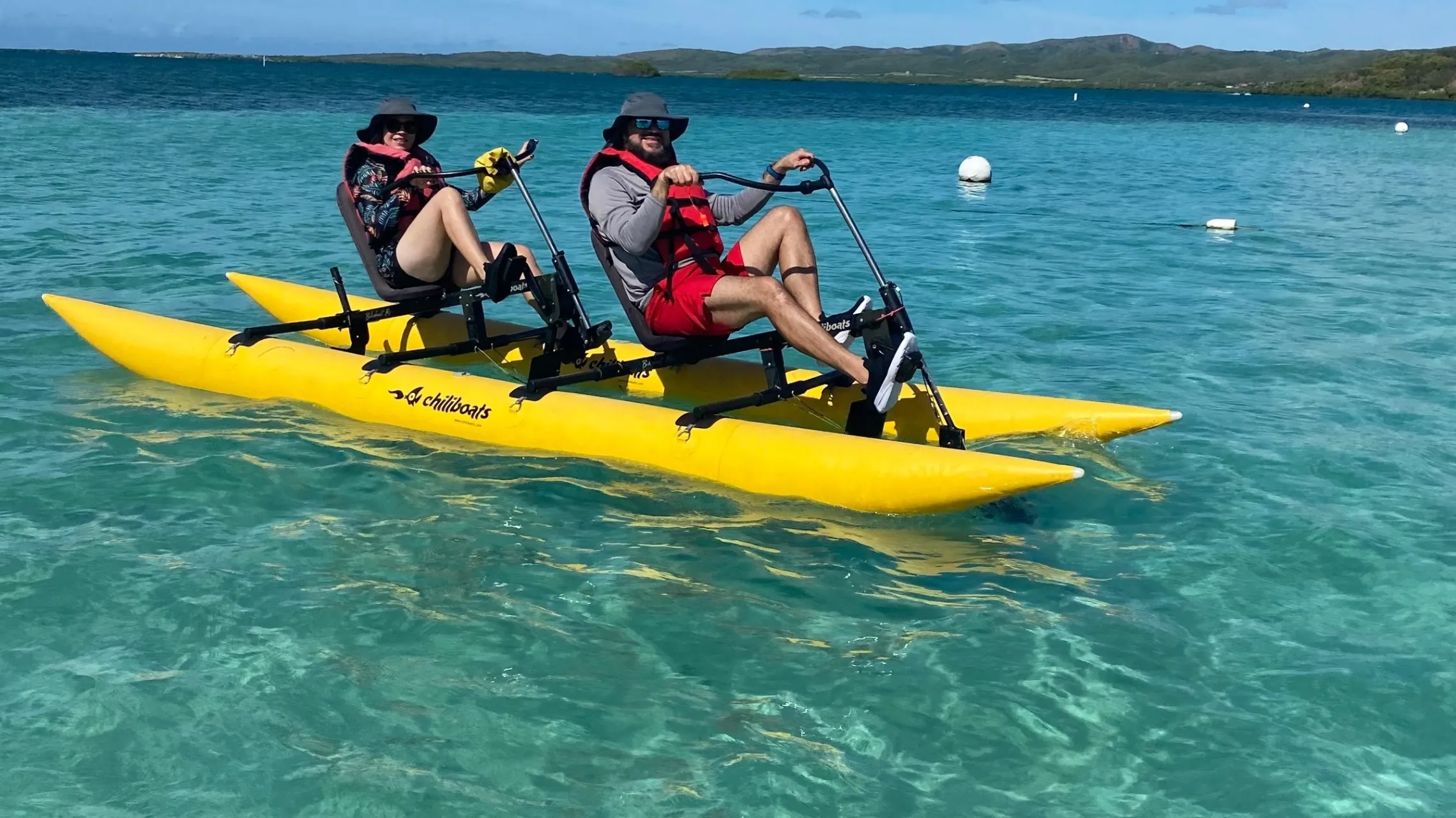a man riding on the back of a boat in a body of water