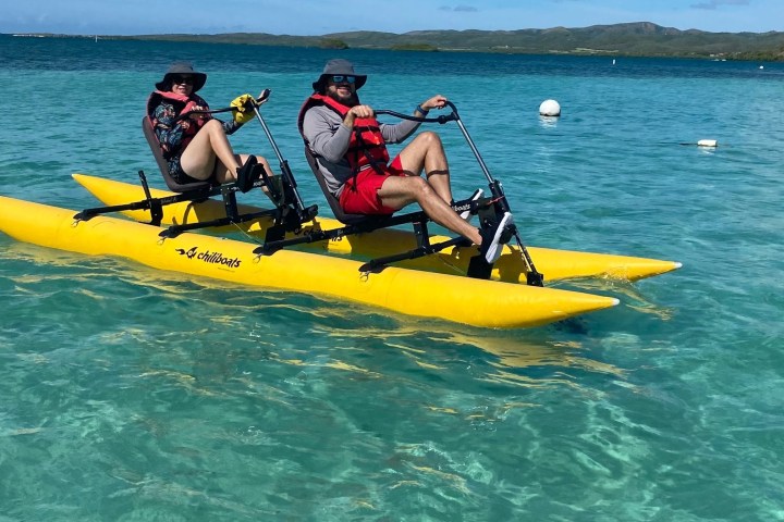 a man riding on the back of a boat in a body of water