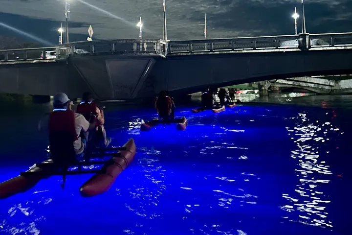 Guests riding Water Bikes beneath Dos Hermanos Bridge during a guided Night Water Bike Tour at Condado Lagoon in San Juan, Puerto Rico, a unique alternative to a traditional Night Kayak Tour.
